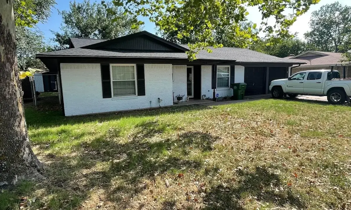 Professional roofing crew working on a residential roof in Stoughton
